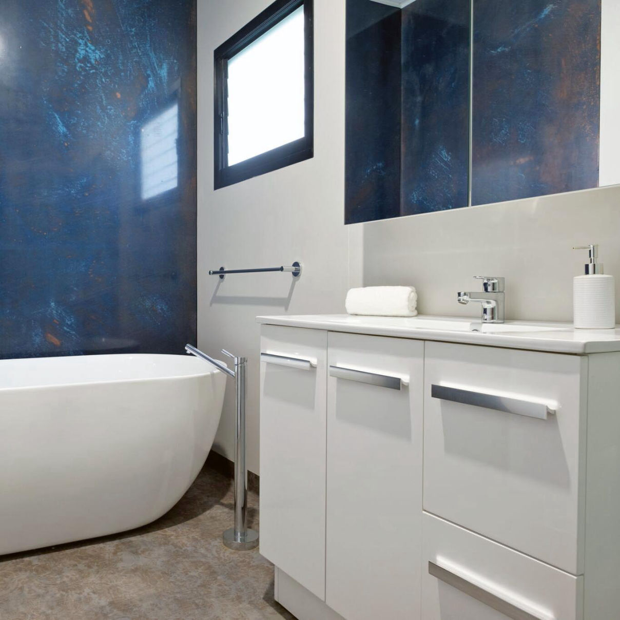 A MAAP House bathroom shows a textured wall behind a freestanding bath